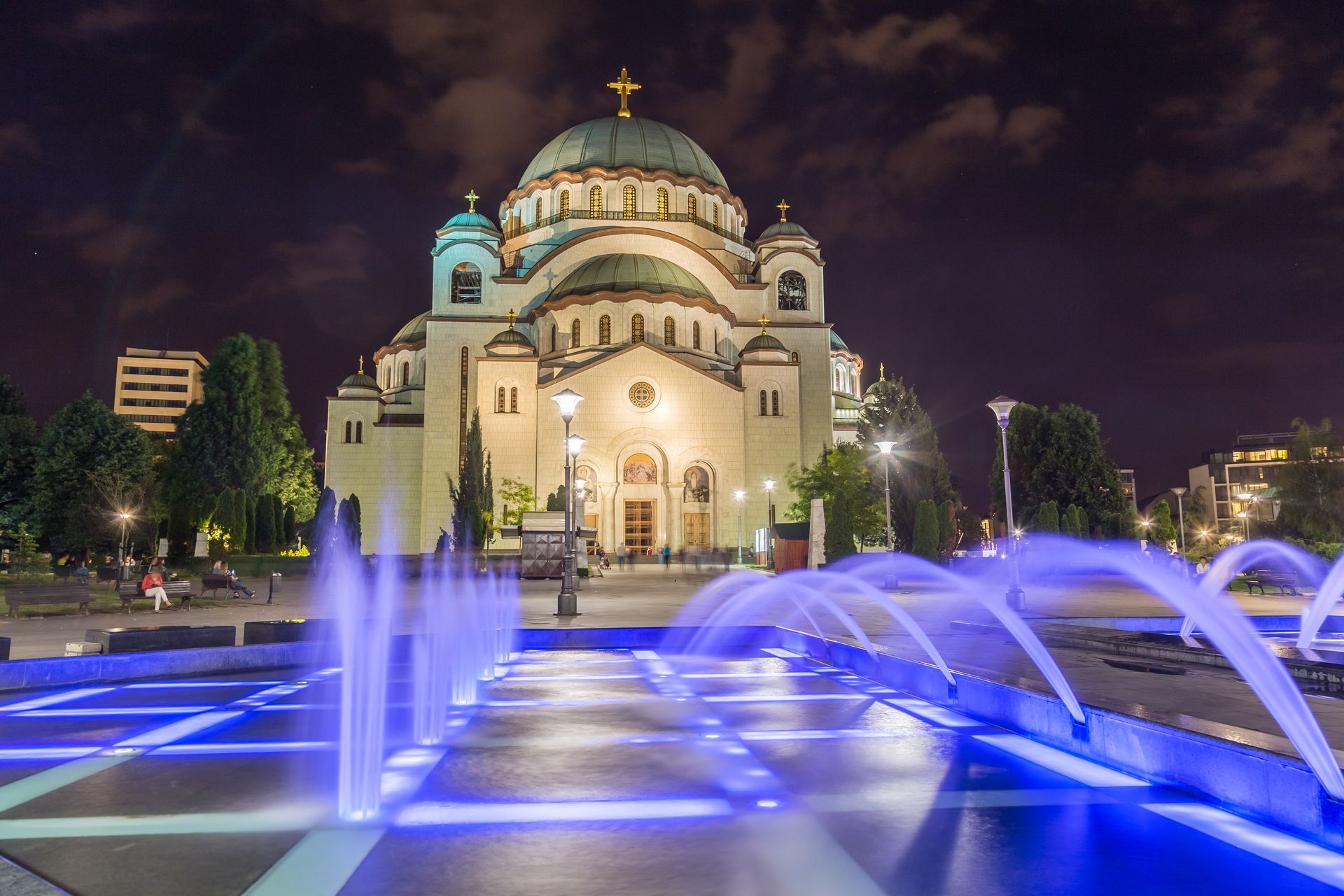 The outside of the front of Church of Saint Sava in Belgrade the capital of Serbia at night. Colourful fountains can be seen in the foreground.